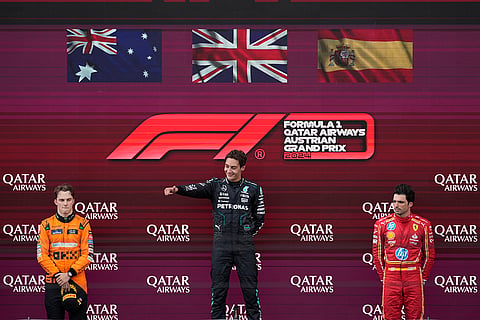 George Russell of Britain, Oscar Piastri of Australia and Carlos Sainz of Spain